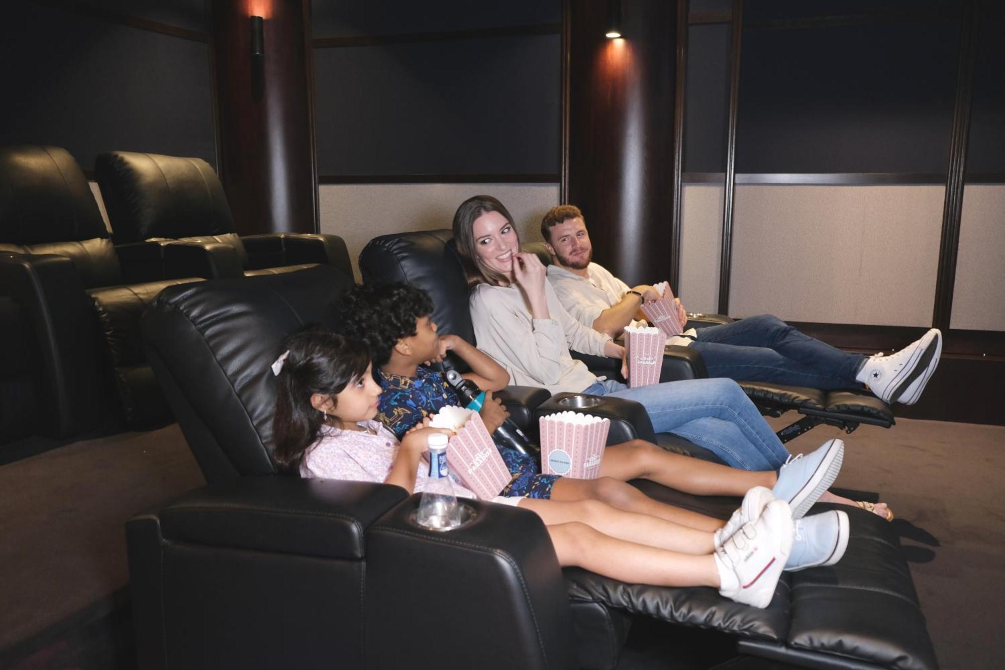 Charthouse Bahrain Hotel มานามา ภายนอก รูปภาพ A family watching a movie in a home theater